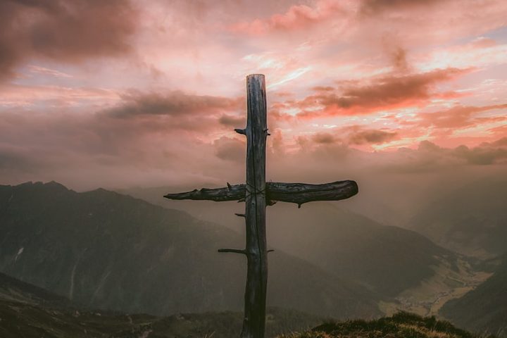 grey wooden cross on mountain